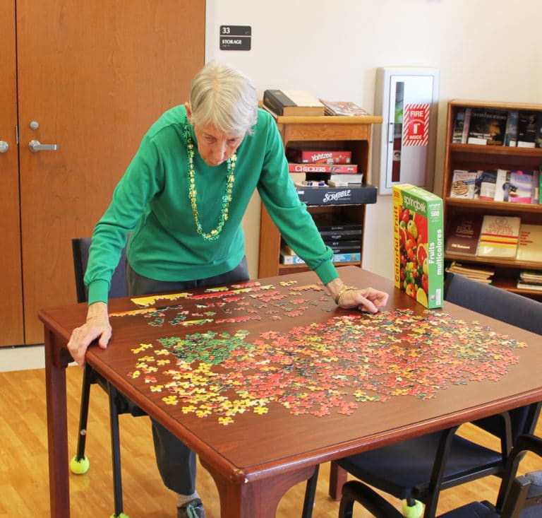Sister Maureen O’Neill gets in some jigsaw puzzling before the party started in the Villa.