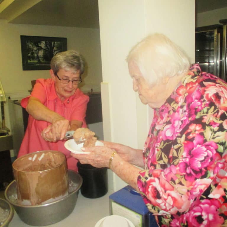 An annual tradition of Community Days is for the members of the Leadership Council to serve ice cream to the sisters. Here Sister Judith Nell Riney fills a bowl for Sister Catherine Kaufman.