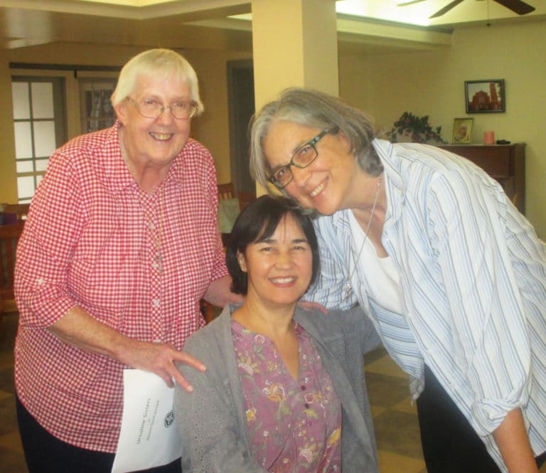 Sister Dianna Ortiz, seated, is joined by Sister Grace Simpson, left, and Sister Larraine Lauter in the dining room.