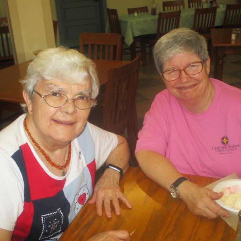 Sister Cecelia Joseph Olinger, left, and Sister Mary McDermott enjoy some conversation over ice cream. Both sisters are celebrating jubilees of religious profession this year.