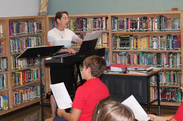 Sister Marilyn Mueth plays the keyboard to lead her third and fourth grade music class in “All Good Gifts.” She also plays the guitar and accordion. Sister Marilyn Mueth plays the keyboard to lead her third and fourth grade music class in “All Good Gifts.” She also plays the guitar and accordion.