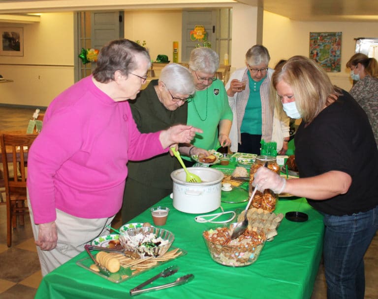The party treats provided by the Finance staff are a favorite for these Sisters. From left are Sisters Melissa Tipmore, George Mary Hagan, Pat Lynch and Ruth Gehres. It was Sister Pat’s feast day.