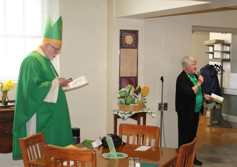 Sister Suzanne Sims introduces Father Ray to give his Saint Patrick performance again for the Sisters in the dining room.