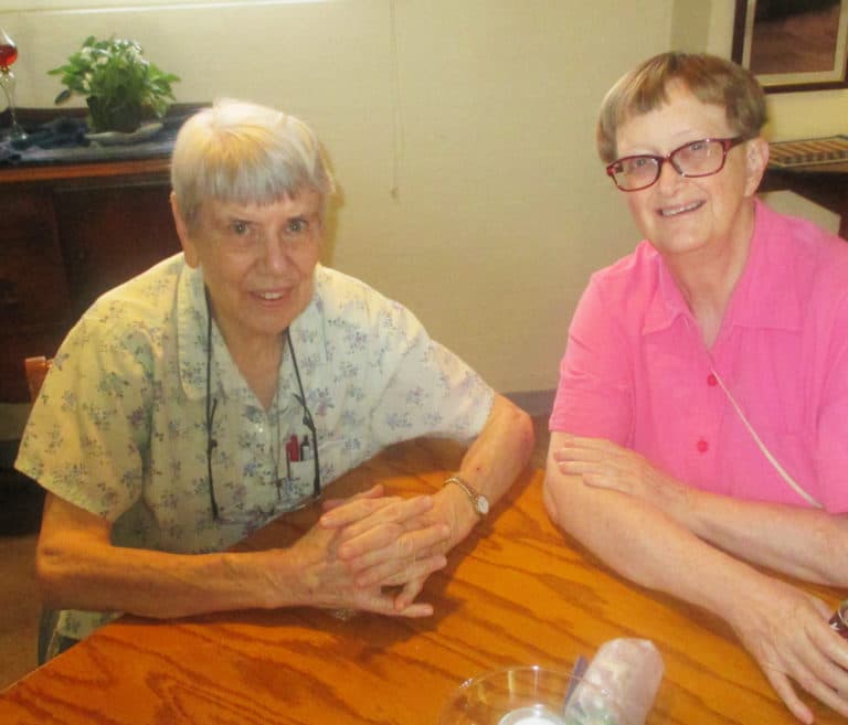 Sister Sheila Anne Smith, left, and Sister Rebecca White spend a little dining room time catching up.