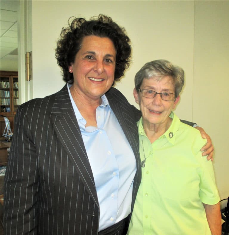 Carolyn Larocco, left, who manages the sisters’ investments, poses with Sister Judith Nell Riney following the discussion of investments. Sister Judith Nell oversees the Finance office.