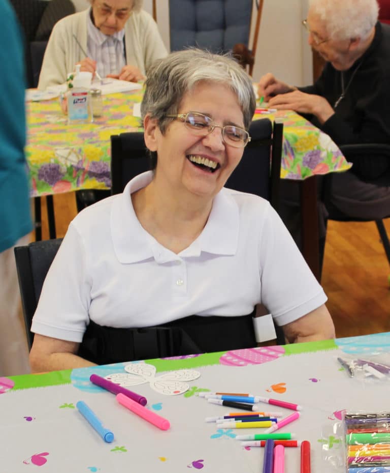 Sister Rose Karen Johnson laughs as she awaits some new markers to begin her project.