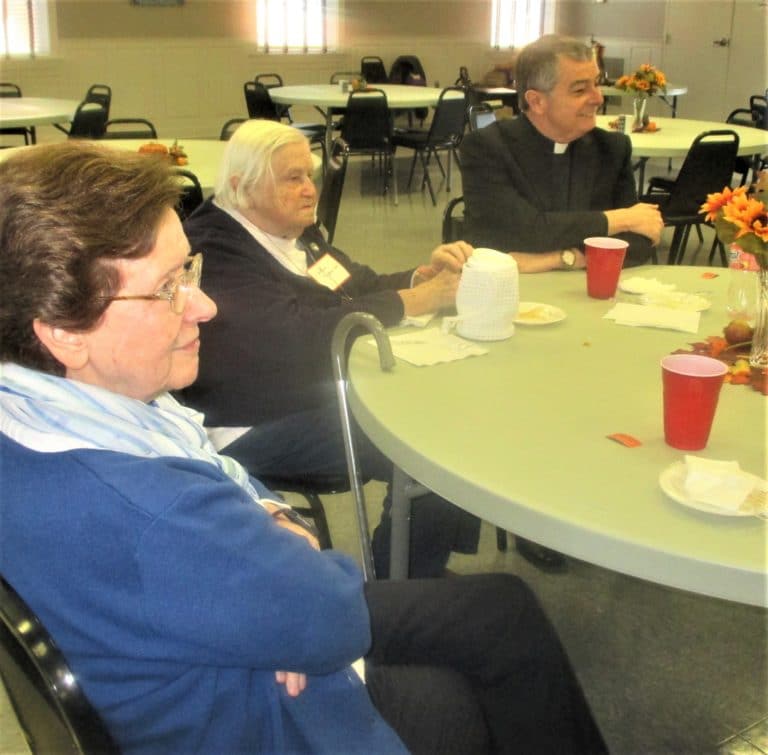 Sister Mary, Sister Catherine and the Most Rev. William Medley enjoy their meal.