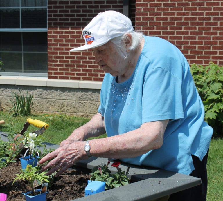 Sister Catherine Kaufman does something unusual for her – planting flowers outside. Sister Catherine is well known for her green thumb and for resurrecting plants that others thought were hopeless, but she usually only plants indoors.