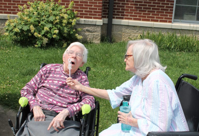We all need a little help now and then. Here, Sister Pat Rhoten, right, assists Sister Marie Julie Fecher with her bubble blowing.