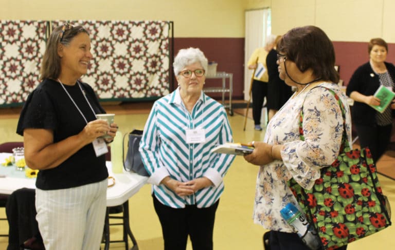 Associate Tina Wolken, left, and Associate Mary Alice Wethington, center, talk with Therese Wilhite prior to the beginning of Associates and Sister Day. Therese made her Associate commitment later in the day.