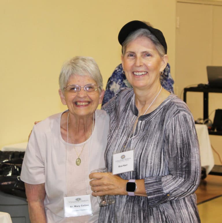 Sister Mary Celine Weidenbenner, left, visits with Western Kentucky Associate Risë Karr during a break.