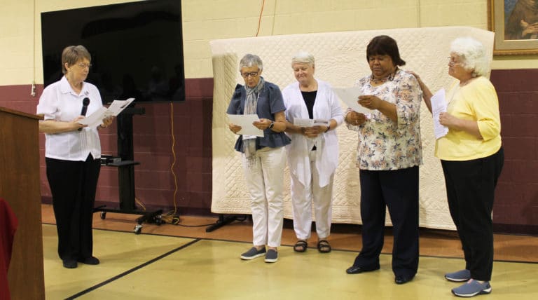 The new Associates read their commitment statements in front of the Associates and Sisters gathered. From left is Sister Amelia Stenger, congregational leader; new Associate Carolyn McCarty and her contact Sister Suzanne Sims; new Associate Therese Wilhite and her Contact Associate Marian Bennett.