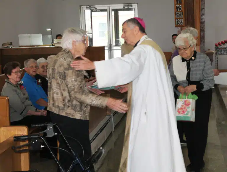 Ursuline Sister Jane Falke receives congratulations from Bishop Medley on her 70 years of service. Ursuline Sister Jane Falke receives congratulations from Bishop Medley on her 70 years of service.