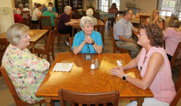 Sister Pam Mueller, center, visits with Carol Braden-Clarke, left, and Doreen Abbott, both of the mission advancement staff.