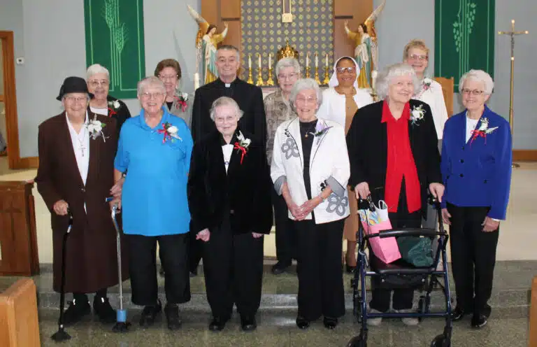 The jubilarians present were joined by Bishop Medley following the event. In the first row from left are Franciscan Sister Lucy Bonifas, and Ursuline Sisters Emma Anne Munsterman, Marie Joseph Coomes, Elaine Burke, Francis Louise Johnson and Barbara Jean Head; in the second row from left are Ursuline Sisters Ann McGrew and Mary Henning, Bishop Medley, Ursuline Sister Jane Falke, Franciscan Sister Consolata Ojemeh, and School Sister of Notre Dame Janette Fennewald. The jubilarians who could not attend were Ursuline Sisters Marie Carol Cecil (75 years), Margaret Marie Greenwell (70 years), and Catherine Marie Lauterwasser (70 years). The jubilarians present were joined by Bishop Medley following the event. In the first row from left are Franciscan Sister Lucy Bonifas, and Ursuline Sisters Emma Anne Munsterman, Marie Joseph Coomes, Elaine Burke, Francis Louise Johnson and Barbara Jean Head; in the second row from left are Ursuline Sisters Ann McGrew and Mary Henning, Bishop Medley, Ursuline Sister Jane Falke, Franciscan Sister Consolata Ojemeh, and School Sister of Notre Dame Janette Fennewald. The jubilarians who could not attend were Ursuline Sisters Marie Carol Cecil (75 years), Margaret Marie Greenwell (70 years), and Catherine Marie Lauterwasser (70 years).