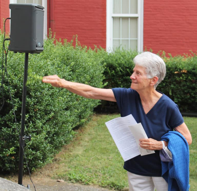 Sprigs from the boxwood bushes in front of the building were dipped in water and the Sisters were offered the chance to bless the building. Sister Joan Riedley, a 1963 Academy graduate, takes her turn blessing the building.