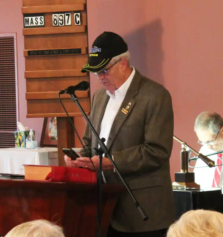 Garry Pierce, a 1968 Brescia graduate and a veteran, leads the opening prayer in the Brescia Chapel.