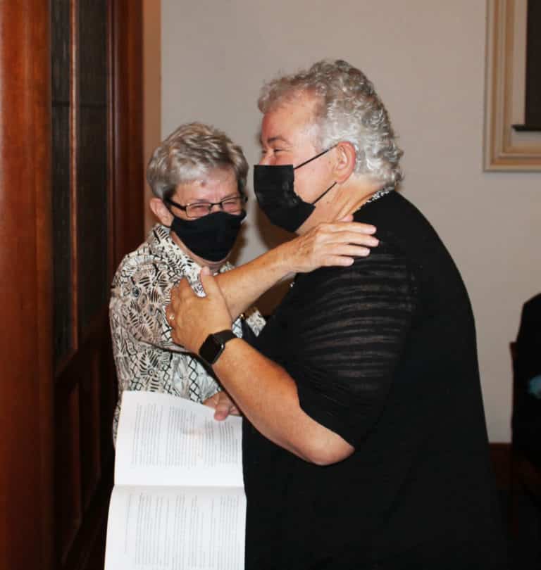 Sister Judith Nell Riney, left, who was leaving office as a councilor, shares a laugh with Sister Martha Keller before her installation as assistant congregational leader.
