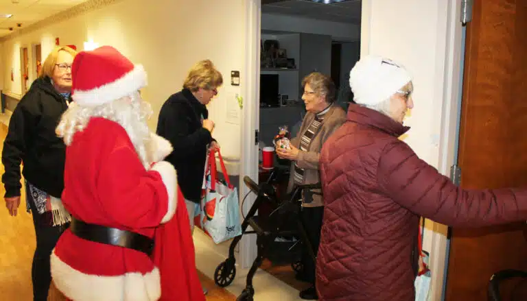 Sister Margaret Ann Aull receives a bag of candy from Rita Tanner, as Mary Ann Willett knocks on another Sister's door.