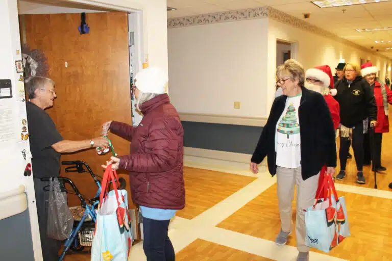 Sister Emma Anne Munsterman receives her candy bag as the 1972 graduates line the hallway in the Villa.