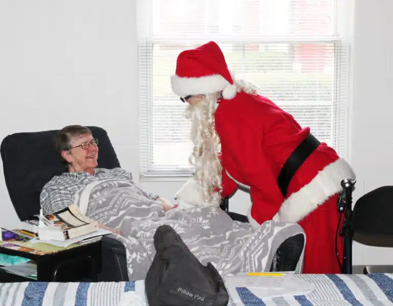 Sister Melissa Tipmore is happy to receive her surprise visit from Jolly Ol' Saint Nick.