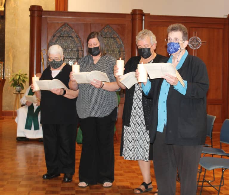 The new Leadership Council reads Saint Angela’s words that “we regard ourselves as ministers and servants, knowing that we have more need to serve, than you have to be served by us.” From left are Sister Ann McGrew, councilor; Sister Monica Seaton, councilor; Sister Martha Keller, assistant congregational leader; and Sister Sharon Sullivan, congregational leader.