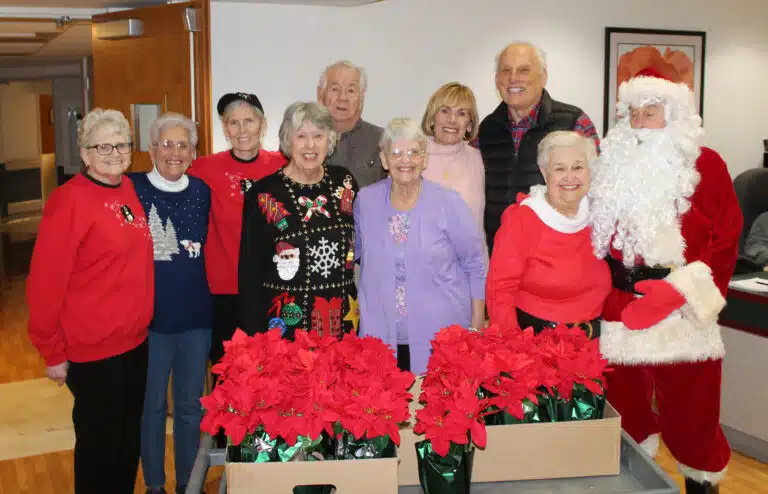 From left are Lois Bell, Betty Boren, Risë Karr, Sid Mason, Mike Sullivan, Sister Mary Celine Weidenbenner, Rosann Whiting, David Leis, Elaine Wood and Santa Claus.