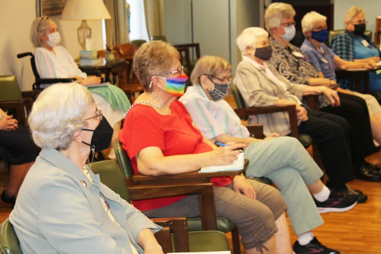 The Sisters listening to Father Ettensohn include, from left, Sister Julia Head, Sister Betsy Moyer, Sister Susanne Bauer, Sister Mary Matthias Ward, Sister Mary Timothy Bland, Sister Barbara Jean Head and Sister Karla Kaelin.