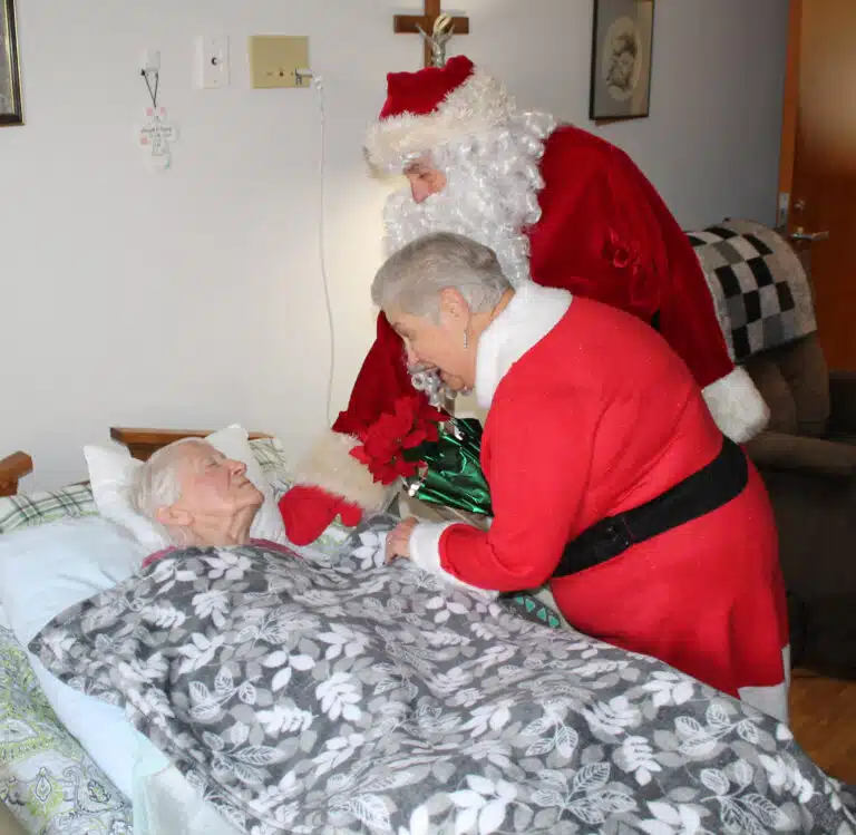 Santa and Mrs. Claus visit Sister Clarita Browning to wish her a Merry Christmas. Santa and Mrs. Claus visit Sister Clarita Browning to wish her a Merry Christmas.