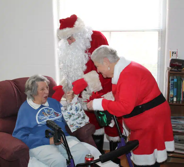 Sister Luisa Bickett is surprised as Santa and Mrs. Claus shower her with gifts. Sister Luisa Bickett is surprised as Santa and Mrs. Claus shower her with gifts.