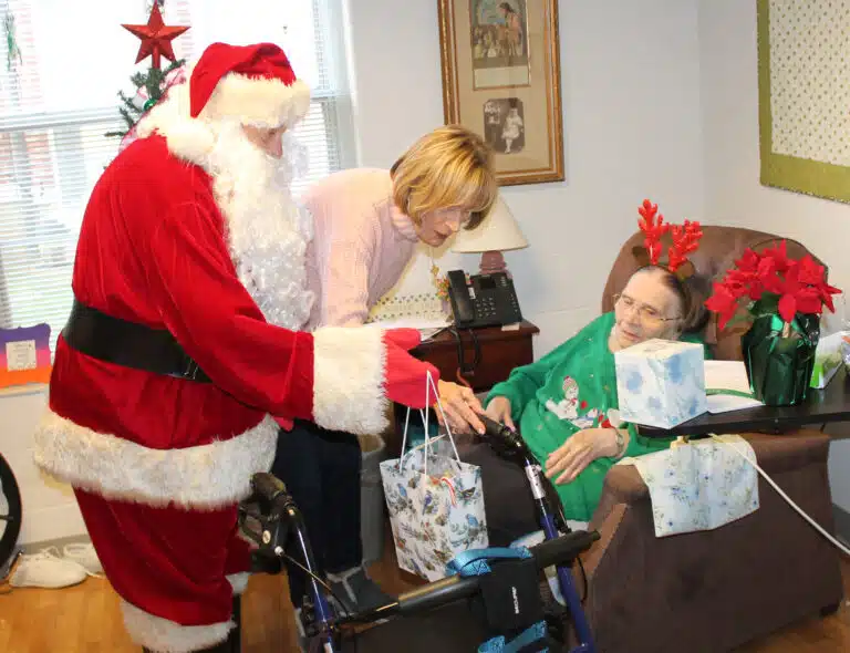 Sister Lois Lindle had her antlers on to celebrate, as she looks for room to place her gifts from Rosann Whiting and Santa Claus. Sister Lois Lindle had her antlers on to celebrate, as she looks for room to place her gifts from Rosann Whiting and Santa Claus.