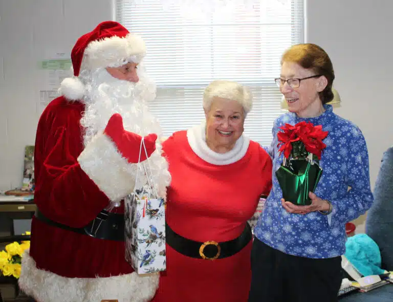 Sister Claudia Hayden shares a laugh with Santa and Mrs. Claus.