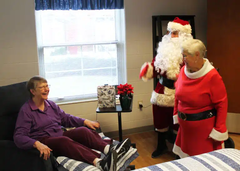 Sister Melissa Tipmore laughs at one of Santa’s jokes as the Claus couple visit her. Sister Melissa Tipmore laughs at one of Santa’s jokes as the Claus couple visit her.