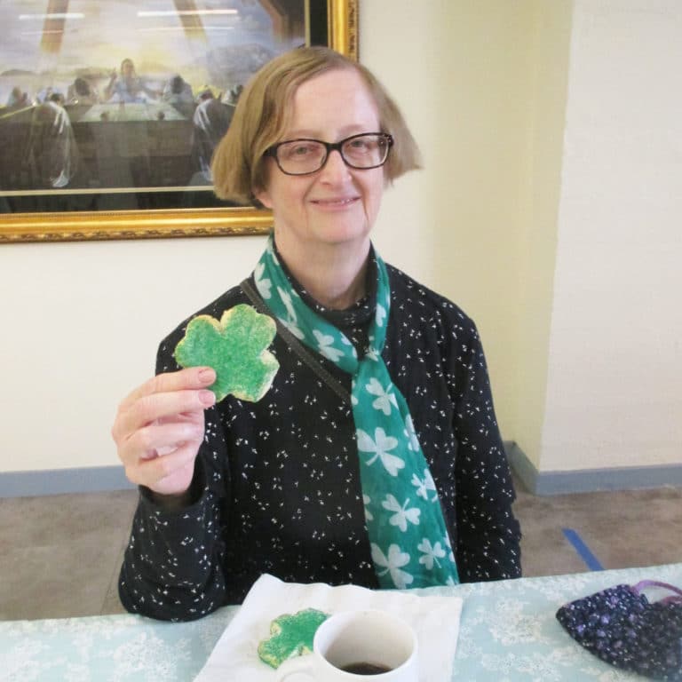 Sister Rebecca White models the correct way to hold a shamrock cookie.