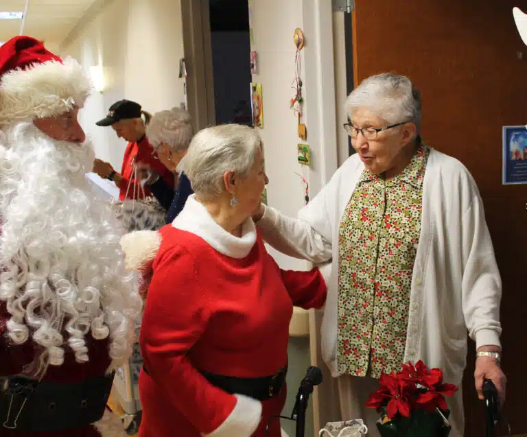 Sister Ruth Gehres greets Elaine Wood and Santa at her door, thankful for the kind presents they brought her. Sister Ruth Gehres greets Elaine Wood and Santa at her door, thankful for the kind presents they brought her.