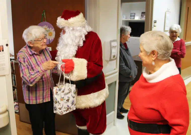 Sister George Mary Hagan has some advice for Santa as he bestows presents on her. Sister George Mary Hagan has some advice for Santa as he bestows presents on her.