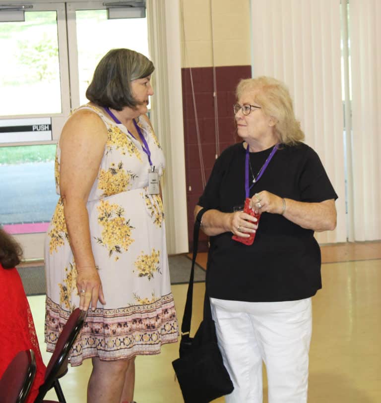 Laquita McIntyre McCarty, A’74, left, talks with WaNell Stallings Lanham, A’71, before the business meeting.