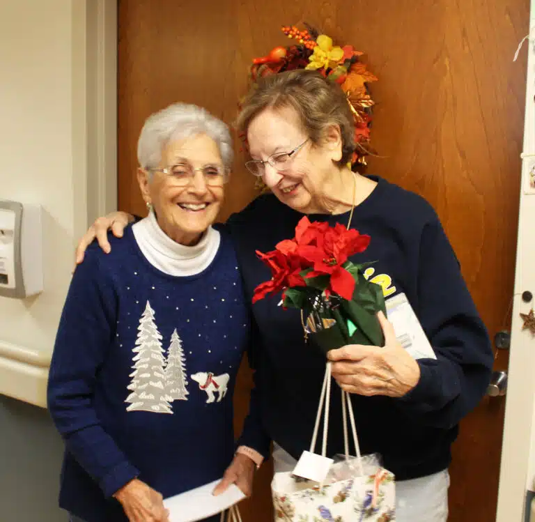 Sister Susan Mary Mudd, right, gives Associate Betty Boren a hug after receiving her gifts. Sister Susan Mary Mudd, right, gives Associate Betty Boren a hug after receiving her gifts.
