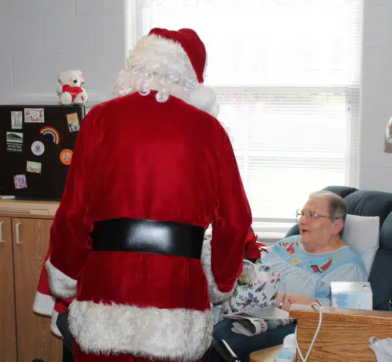 Sister Kathleen Dueber sings some Christmas carols with Santa and Mrs. Claus. Sister Kathleen Dueber sings some Christmas carols with Santa and Mrs. Claus.