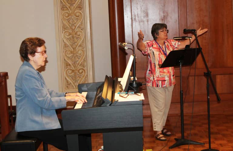 Becky Collins Morris, A’71, right, served as cantor during Mass, as Sister Mary Henning A’64, played the music.