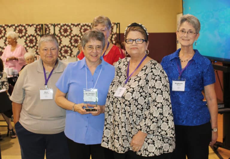 Sister Jacinta Powers A’72, second from left, holds her Maple Leaf Award, as her nominator and classmate, Sarah Kranz, stands to the right. Also pictured from left are alumnae officers Mary Danhauer, Paula Chandler Gray and Stephanie Warren.