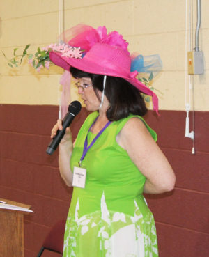 Carolyn Sue Cecil, A73, Alumnae Association president, welcomes everyone to the banquet sporting her fabulous Kentucky Derby hat.
