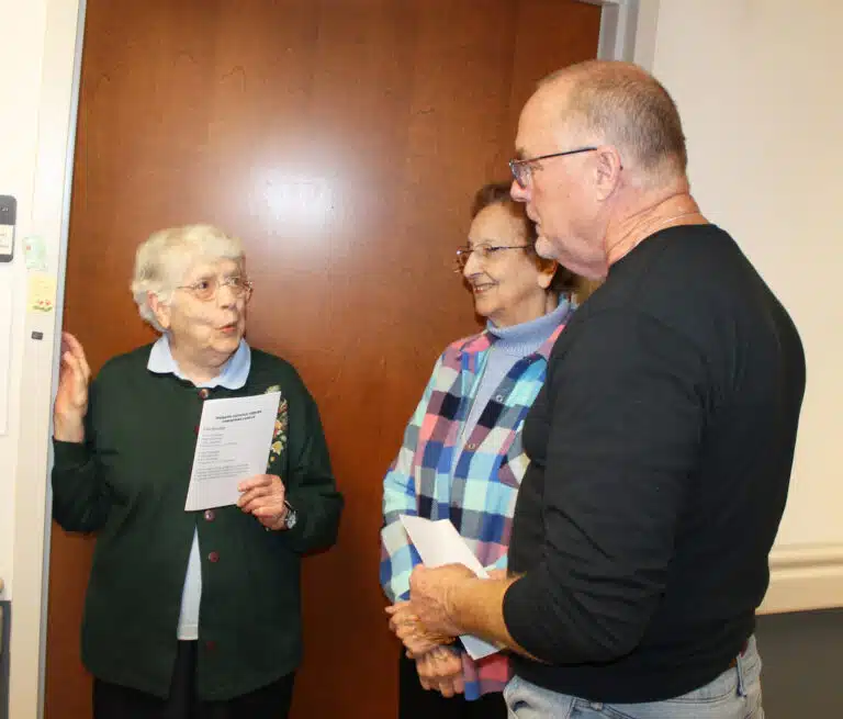 Bill Blincoe, director of Project and Risk Management for the diocese, asks Sister Michael Ann Monaghan, left, and Sister Susan Mary Mudd where they grew up.