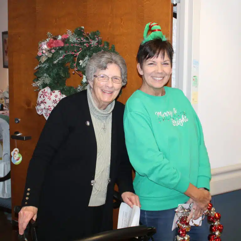 Patti Bartley, right, who works with the Marriage Tribunal for the diocese, shares a smile with Sister Margaret Ann Aull.
