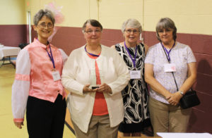 Anna Mattingly, A66, second from left, poses with her Maple Leaf Award. At left is Stephanie Warren, vice president of the Alumnae Association, and to the right of Anna are her sisters and nominators for the award, Mary Lou Mattingly O’Brien, A68, and Patricia Mattingly Arnett, A72.