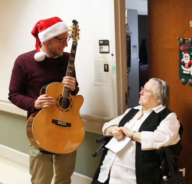 Danny May chats with Sister Catherine Marie Lauterwasser outside her room. Sister Catherine Marie was a music teacher for much of her life, and made sure to get her seat early to join in with the carolers.