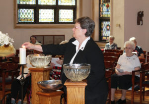 Sister Amelia Stenger, congregational leader, lights her candle. Sister Amelia came to the Mount as a student in 1963.