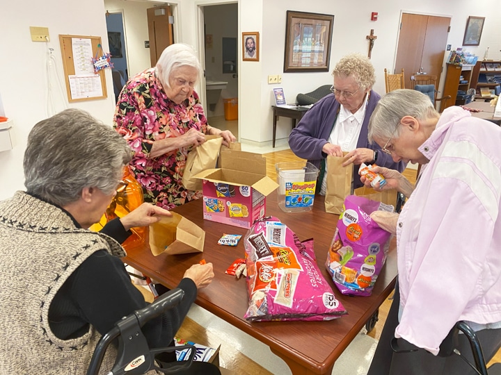 Ursuline Sisters prepare bags of candy as they prepare for trick-or-treaters to arrive at their rooms. From left are Sisters Margaret Ann Aull, Catherine Kaufman, Marie Joseph Coomes and Amanda Rose Mahoney.