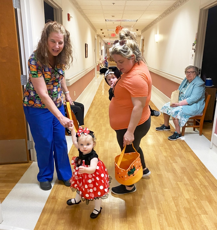 There’s just something about a girl in a polka dot dress, as the granddaughter of Cathy the physical therapist can attest. In the background, Sister Paul Marie Greenwell awaits her next visitor.