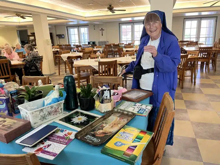 Sister Mary Thomas Simon, a Lamb of God Sister, looks over the table of prize winnings. Sister Mary Thomas Simon, a Lamb of God Sister, looks over the table of prize winnings.